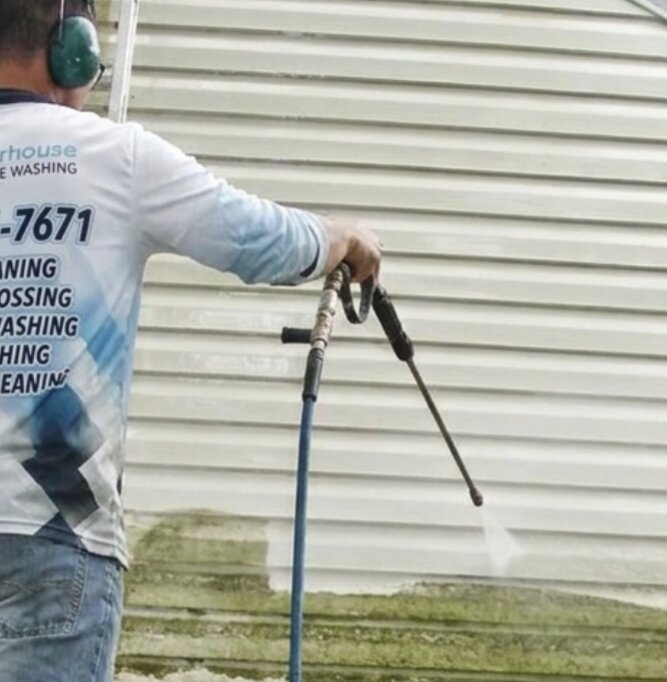 Detail soft-wash on the side of a Langley home with eco-friendly chemicals being applied